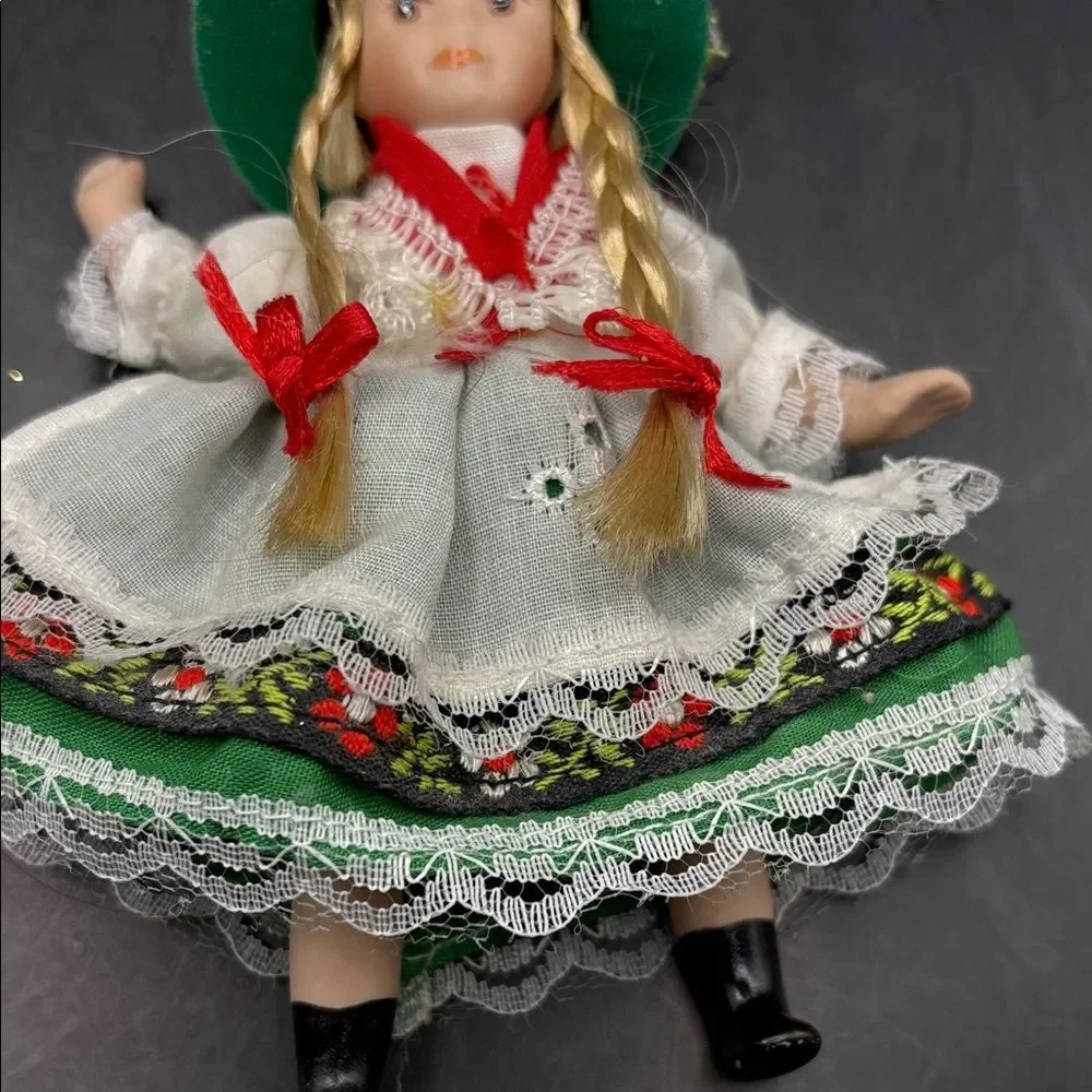 Traditional vintage porcelain doll with Green Hat and Dress